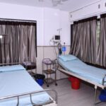 Image showing twin beds in room of Mandhaniya Cancer Hospital of Nagpur